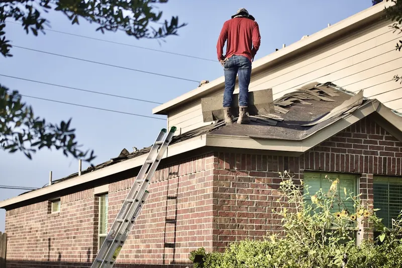 Professional roofer working on a residential roof in Saint Francis